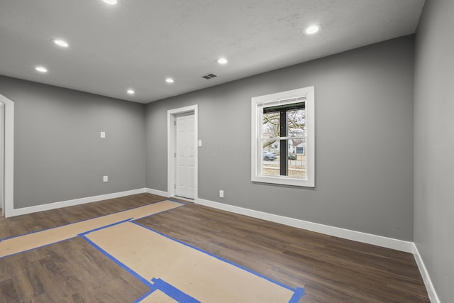 interior space with recessed lighting, visible vents, dark wood finished floors, and baseboards