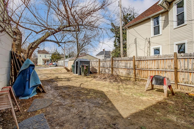 view of yard featuring a fenced backyard and an outdoor structure