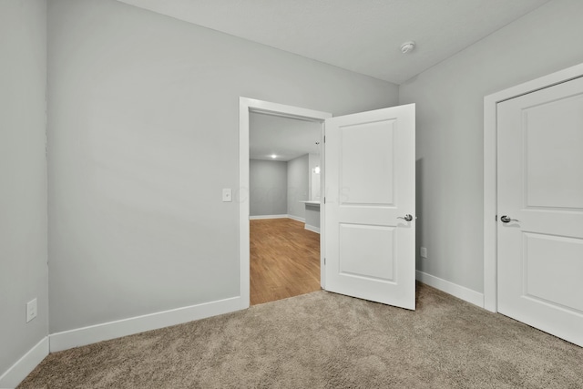 unfurnished bedroom featuring carpet flooring and baseboards