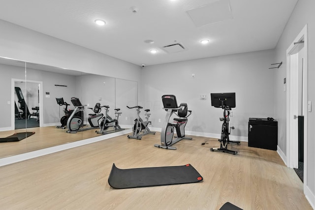 gym featuring wood finished floors and baseboards