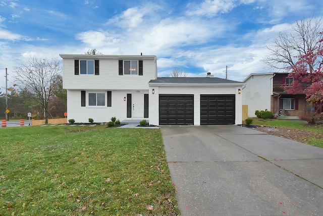 view of front of property featuring a front yard, concrete driveway, and an attached garage