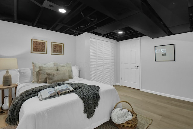 bedroom with baseboards and wood finished floors