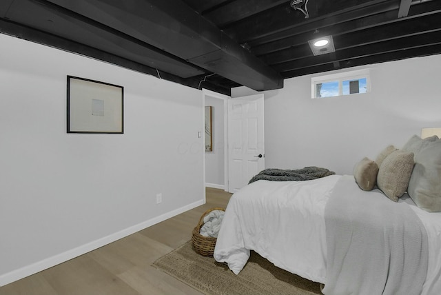 bedroom with baseboards and wood finished floors