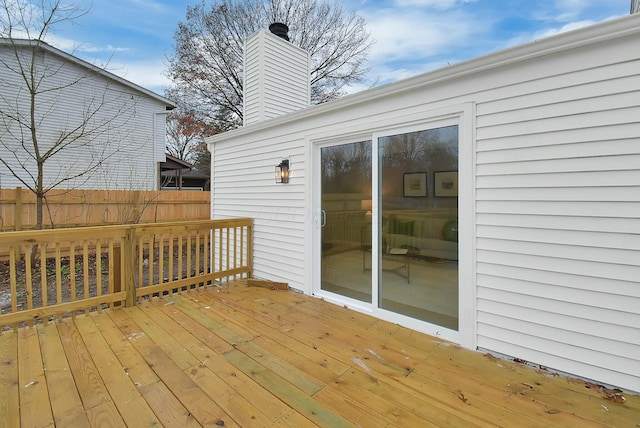 wooden terrace featuring fence