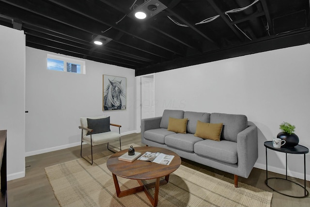 living room with baseboards and wood finished floors