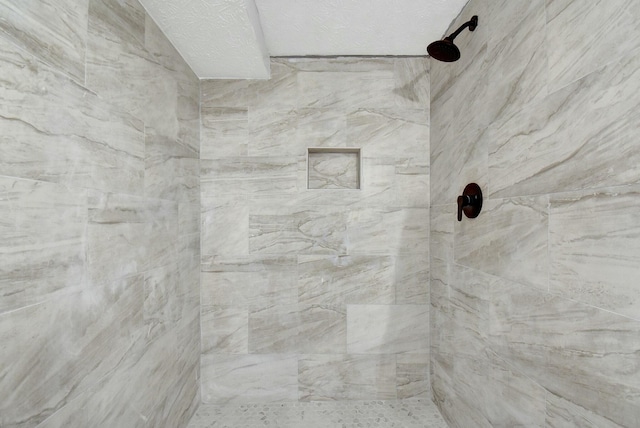 bathroom with tiled shower