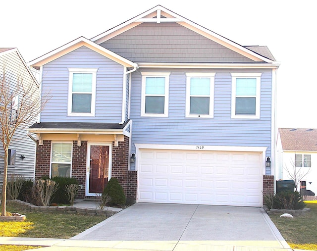 view of front of property with a garage, brick siding, and driveway