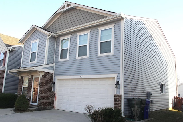 view of front of property featuring brick siding, driveway, and a garage