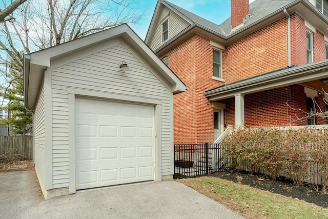 detached garage featuring fence