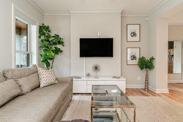 living area featuring light wood-style floors, crown molding, and baseboards