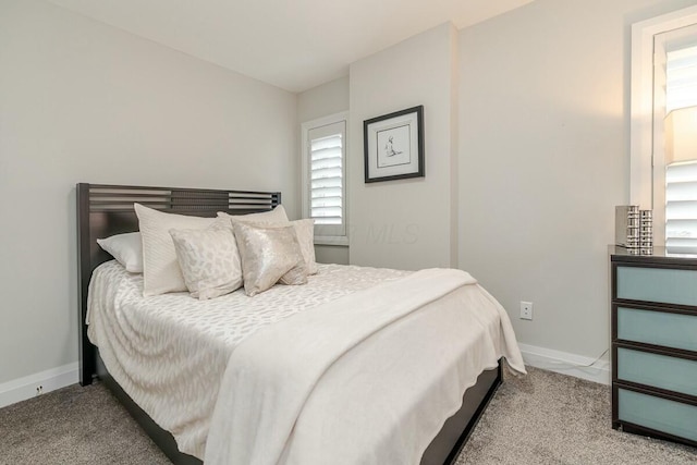 carpeted bedroom featuring baseboards