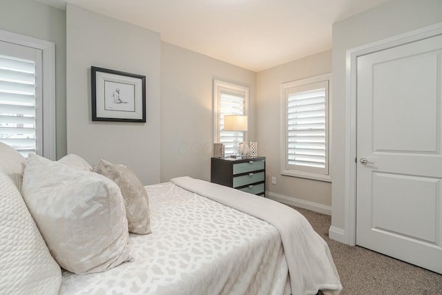 carpeted bedroom featuring baseboards