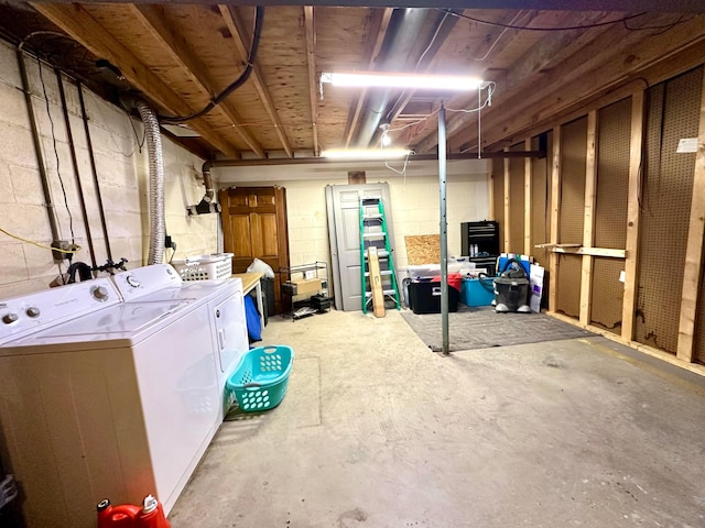 unfinished basement with independent washer and dryer and concrete block wall