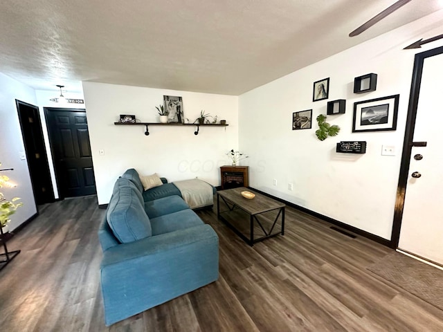 living area with visible vents and wood finished floors