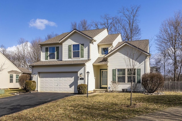 traditional-style home featuring a garage, driveway, a shingled roof, and fence