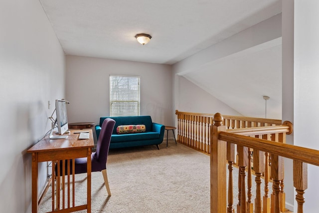 carpeted home office featuring lofted ceiling