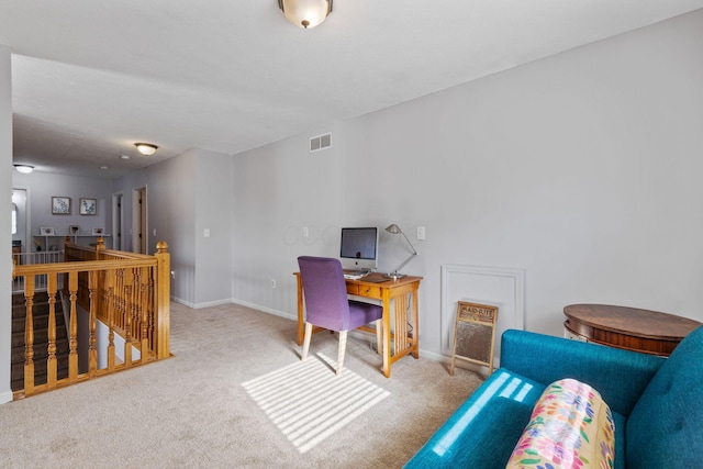 carpeted office with visible vents and baseboards