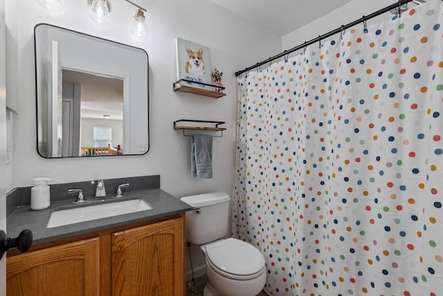 bathroom with a shower with shower curtain, vanity, and toilet