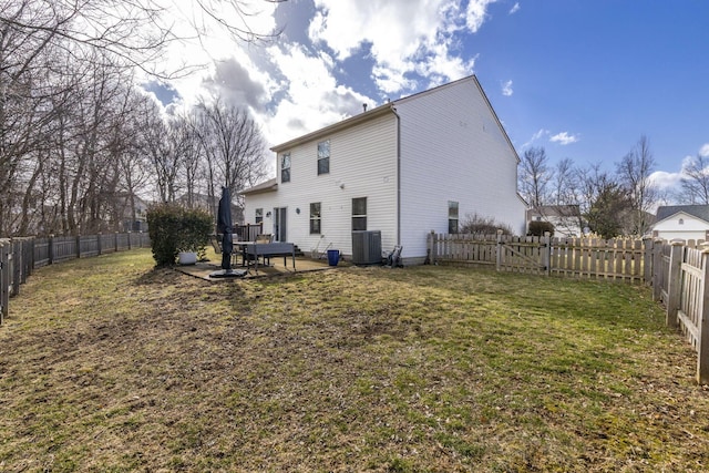 back of house featuring a yard, a fenced backyard, a patio, and cooling unit