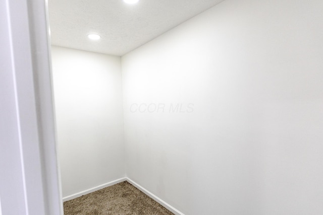 interior space featuring baseboards and a textured ceiling