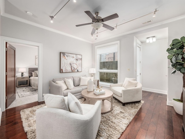 living room featuring dark wood-style floors, rail lighting, and crown molding