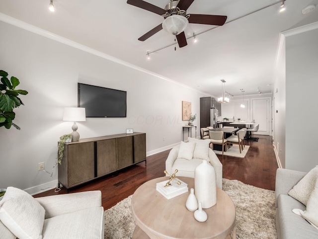 living room featuring dark wood-type flooring, ornamental molding, and track lighting