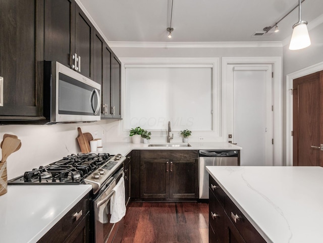 kitchen with visible vents, appliances with stainless steel finishes, dark wood-style flooring, decorative light fixtures, and a sink