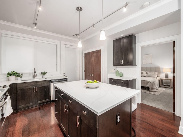 kitchen with light stone counters, appliances with stainless steel finishes, dark wood-type flooring, and a sink