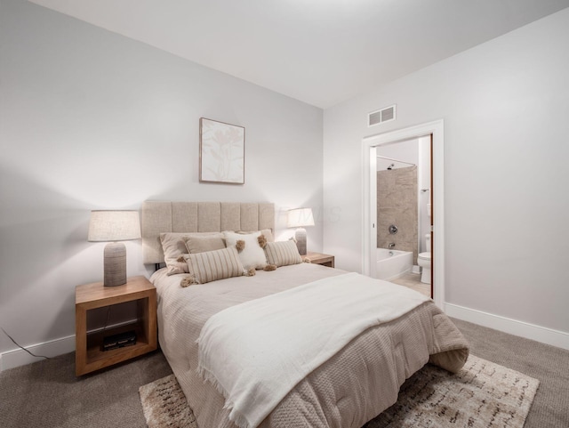 carpeted bedroom with visible vents, connected bathroom, and baseboards