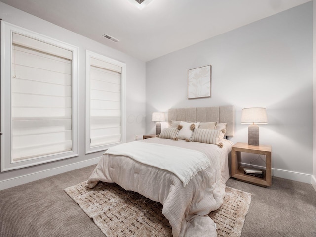 bedroom with carpet, visible vents, and baseboards