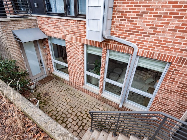 property entrance with brick siding