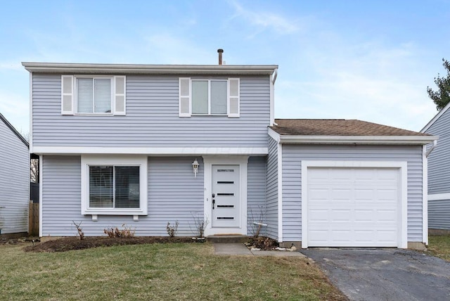 colonial home featuring a garage, a front lawn, and aphalt driveway