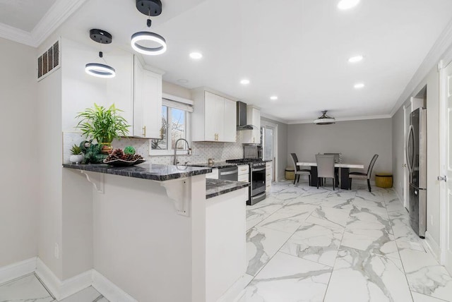 kitchen featuring visible vents, decorative backsplash, appliances with stainless steel finishes, ornamental molding, and wall chimney exhaust hood