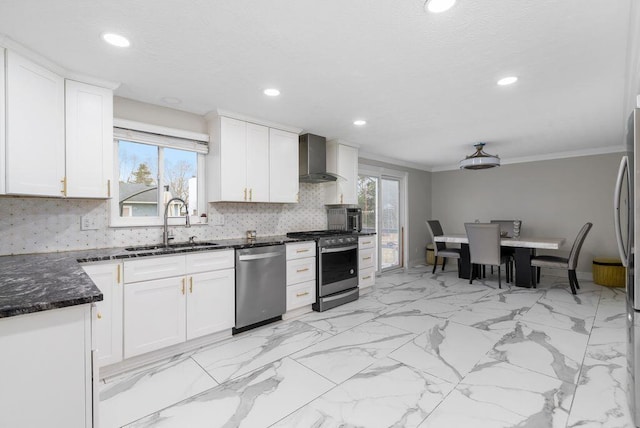 kitchen with backsplash, appliances with stainless steel finishes, a healthy amount of sunlight, a sink, and wall chimney range hood