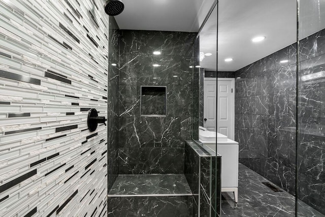 bathroom featuring washer / dryer, marble finish floor, and walk in shower