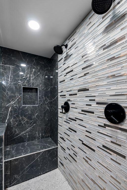 bathroom with a tile shower