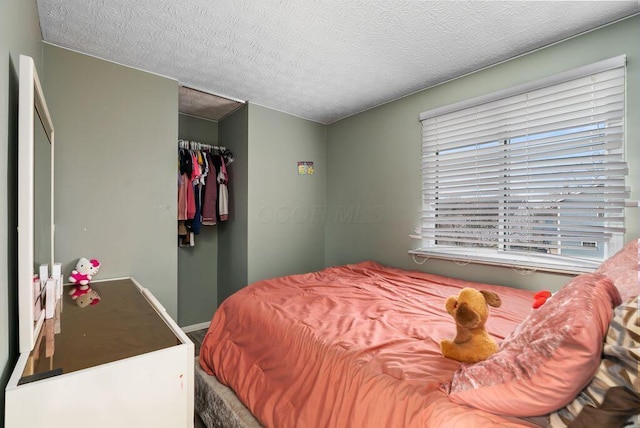 bedroom featuring a textured ceiling and a closet