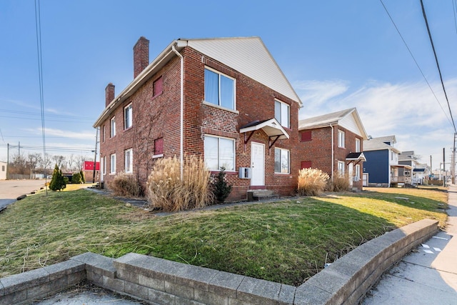 view of property exterior with a yard, a chimney, and brick siding