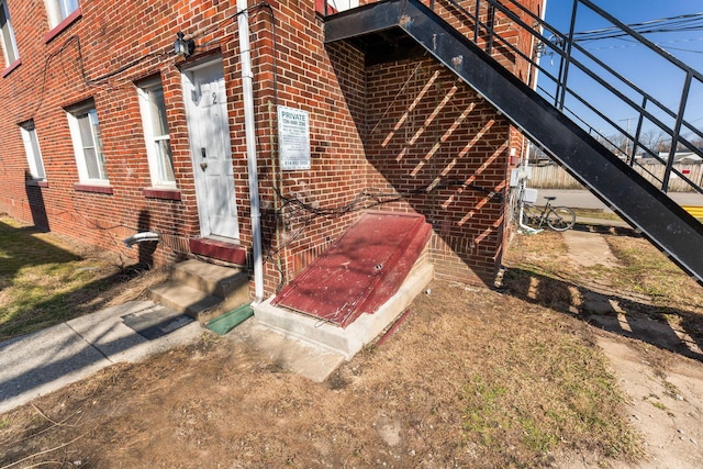 view of property exterior featuring entry steps and brick siding