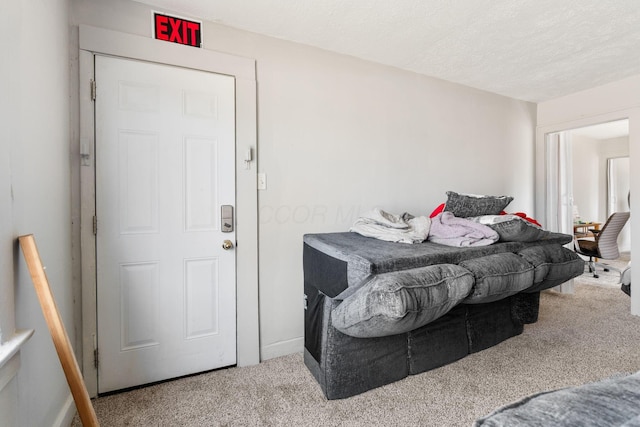 carpeted bedroom featuring a textured ceiling