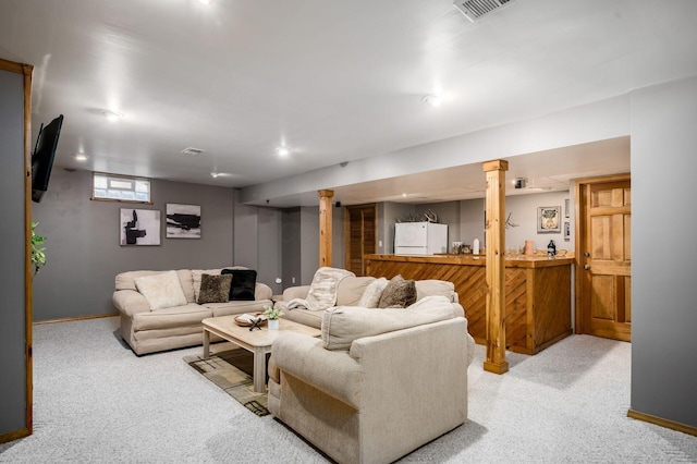 living room featuring carpet, visible vents, and baseboards