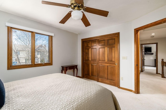 bedroom with light carpet, a ceiling fan, recessed lighting, a closet, and baseboards