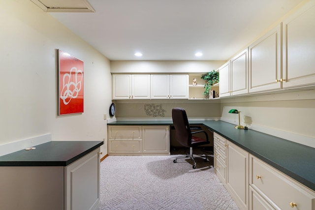 carpeted office with recessed lighting and built in study area