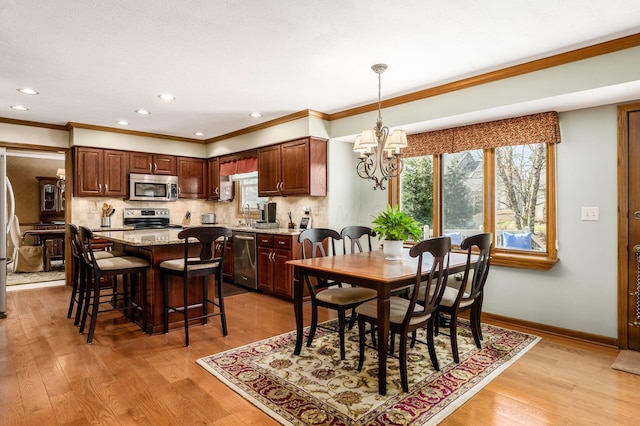 dining area featuring a wealth of natural light, light wood-style floors, and baseboards