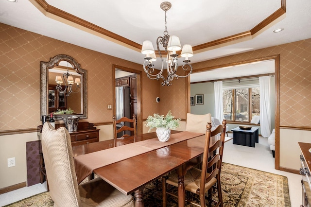 dining room with wallpapered walls, crown molding, and a tray ceiling