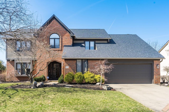 view of front facade featuring brick siding, an attached garage, concrete driveway, and a shingled roof