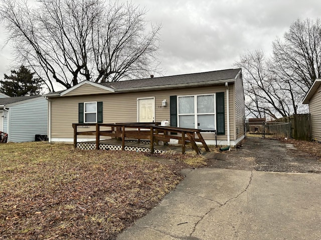 view of front of house featuring fence and a wooden deck