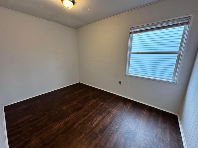 unfurnished room with dark wood-style flooring