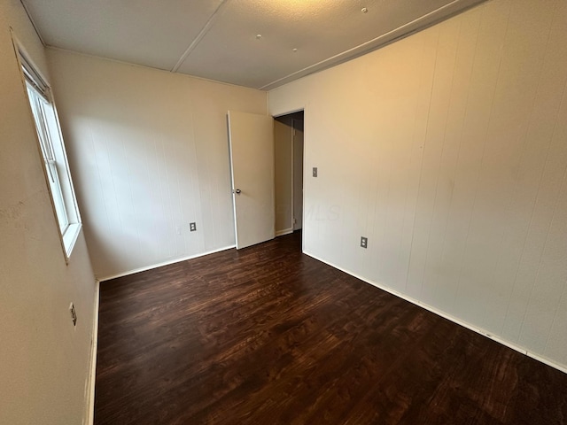 empty room with wood finished floors