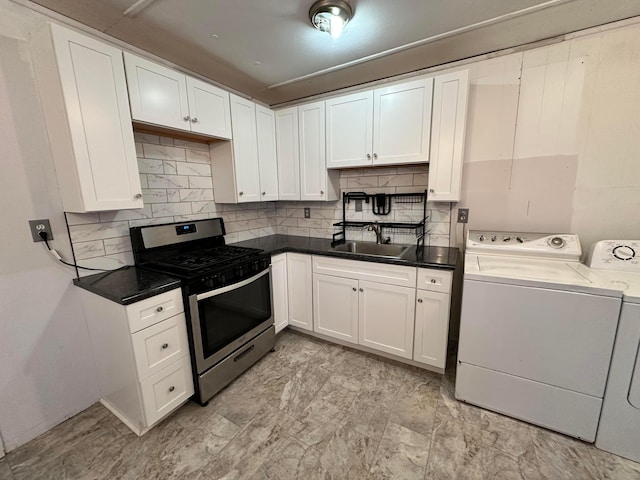 kitchen with decorative backsplash, independent washer and dryer, stainless steel range with gas cooktop, white cabinetry, and a sink